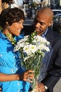 african american woman receiving a bouquet of flowers from an african american man