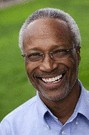 older man wearing a blue shirt and glasses