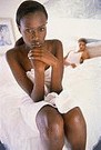 upset woman sitting on the side of the bed