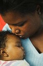 mother kissing baby on the forehead