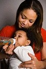 mother giving baby a bottle