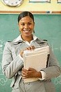 smiling african american teacher in classroom