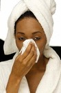woman blowing her nose