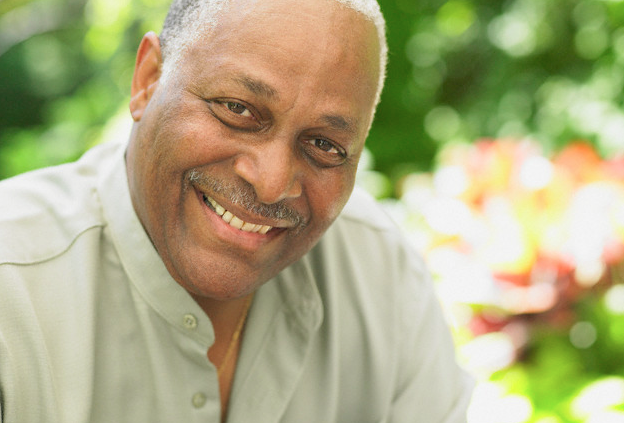 An older man smiling brightly