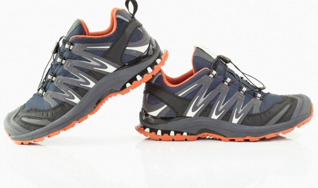 A pair of grey and orange running shoes