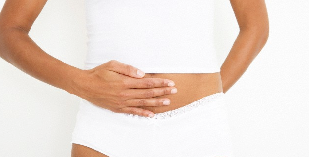 A woman with her hand resting on her stomach