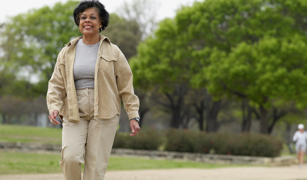 An older woman walking in a park