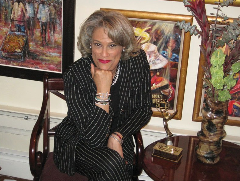 Rae Lewis Thornton posing near artwork