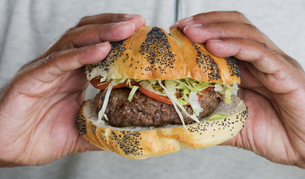 African American Black man's hands holding a burger