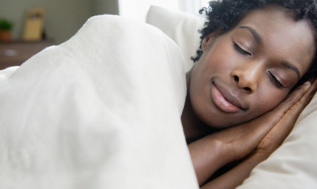 A woman sleeping soundly in her bed