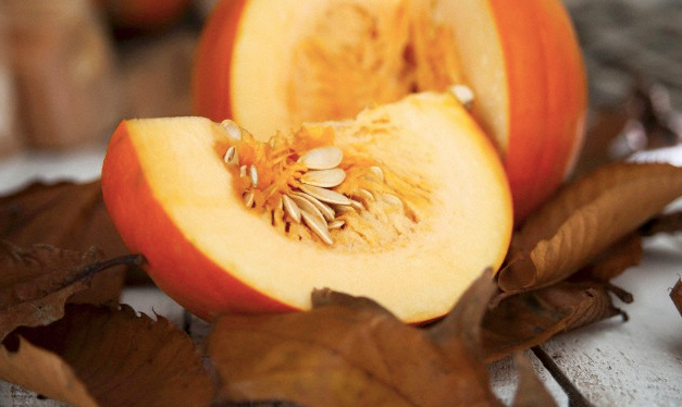 Pieces of pumpkin sitting on leaves