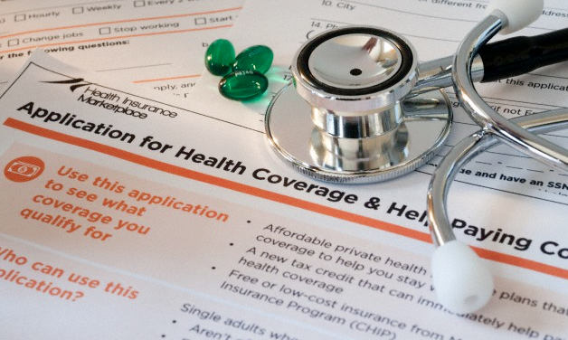An application for health insurance, a stethoscope and some pills