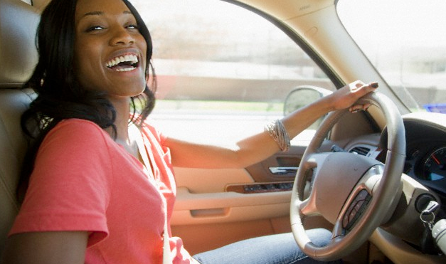 A woman smiling in her car