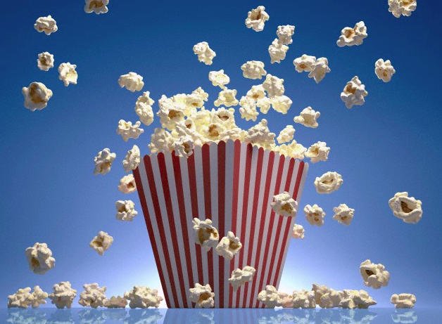 A striped bucket filled with exploding popcorn
