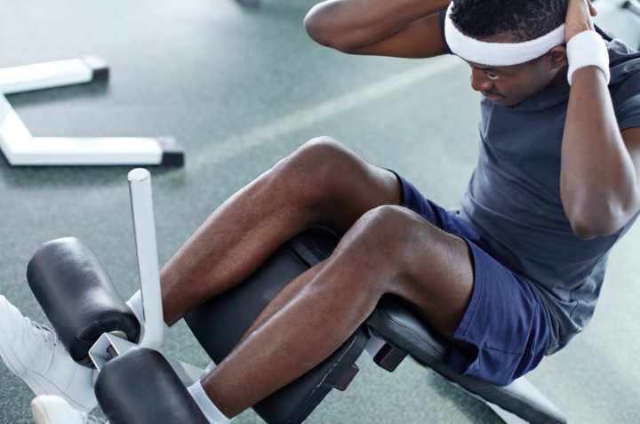 A man doing crunches at the gym