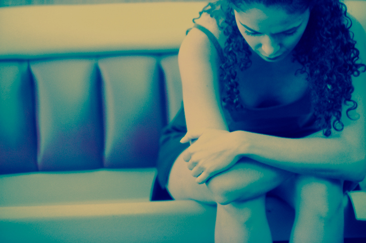 young woman sitting on couch