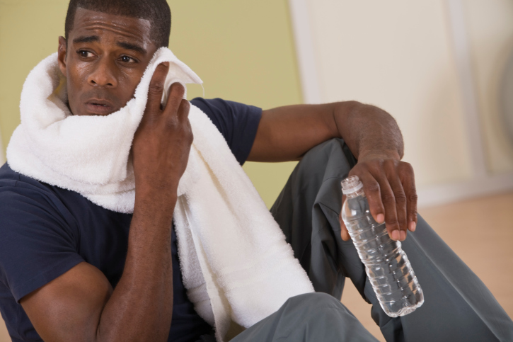 Man with bottled water and towel