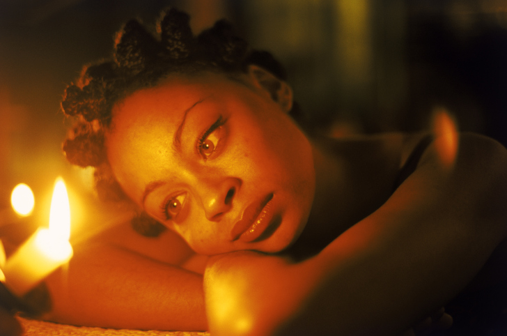 woman relaxing by candles