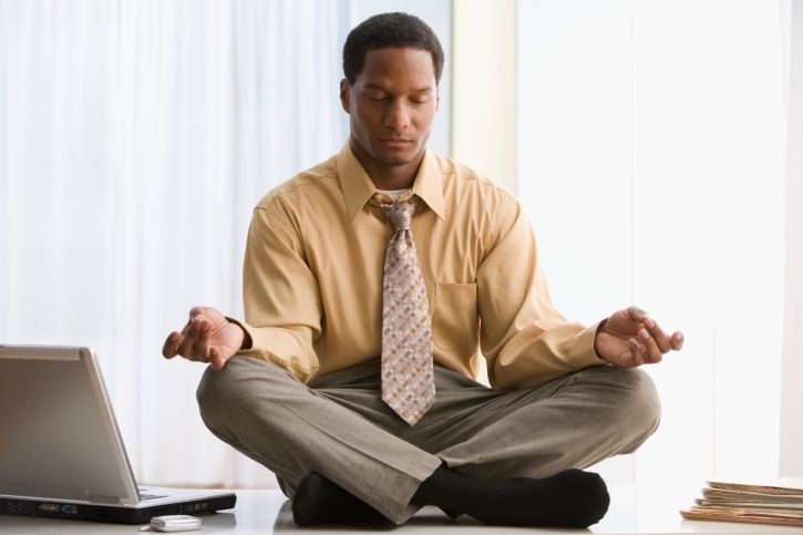 man meditating at work