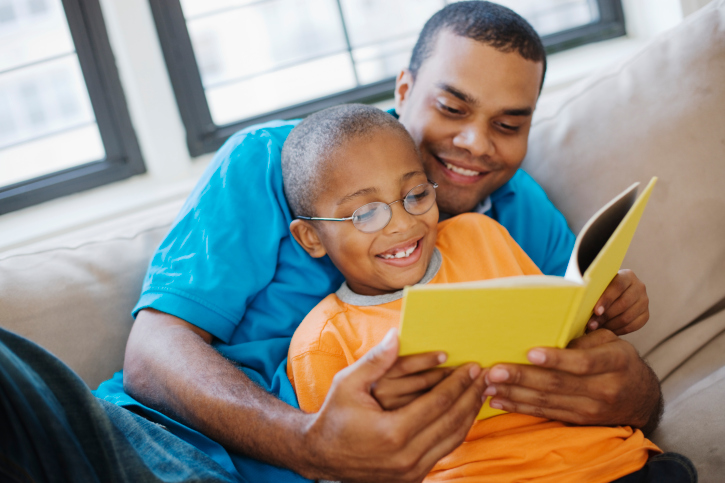 father and son reading together