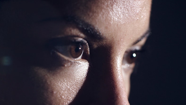 An extreme close up of a female athletes brown eyes, heavily focused on her mission.