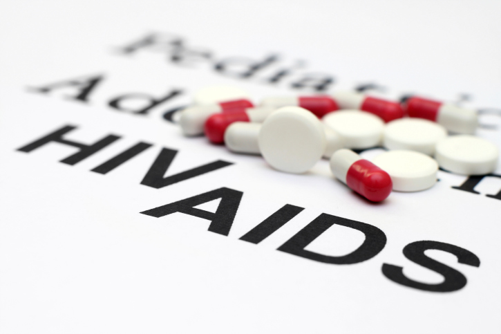 aids on paper with prescription pills on top