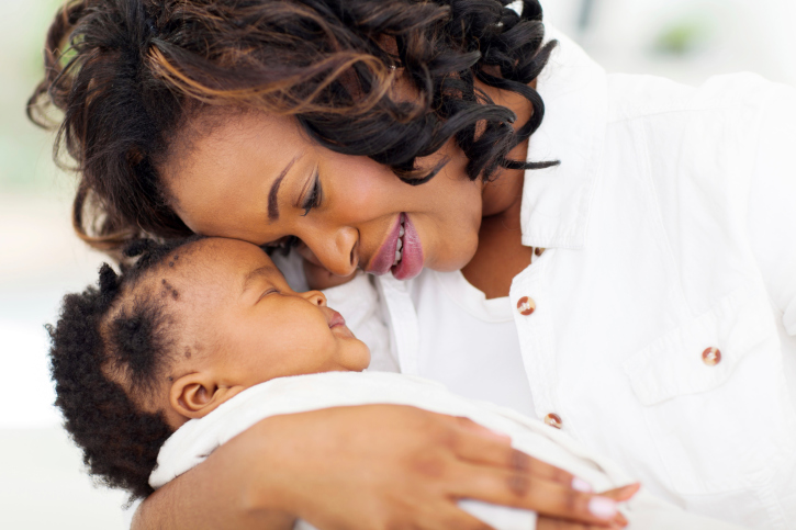 african mother holding sleeping baby daughter