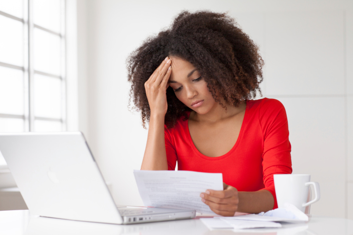 stress woman looking at sheet of paper