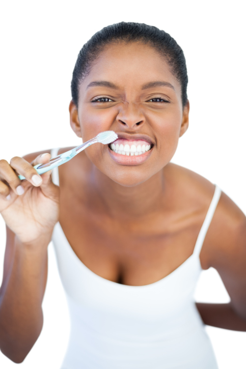 woman with toothbrush smiling