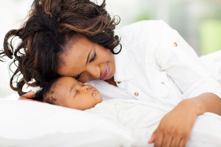 mother watching sleeping baby