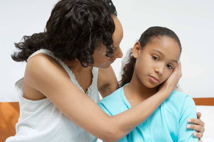 mother comforting daughter