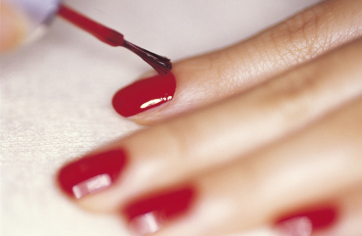 woman polishing finger nails