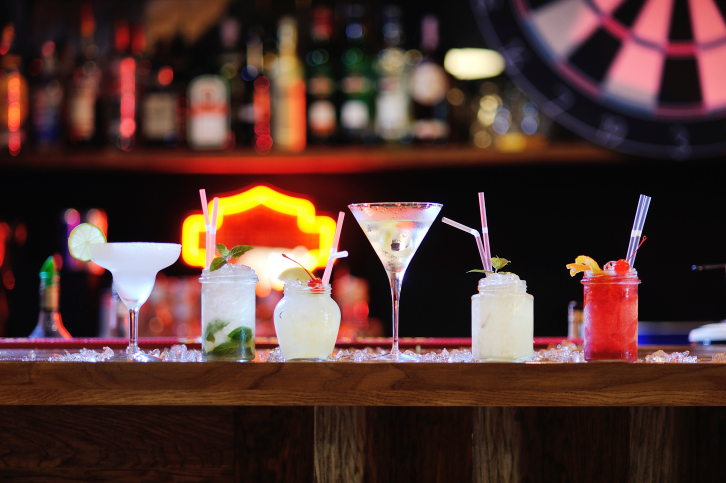 six cocktails on a bar