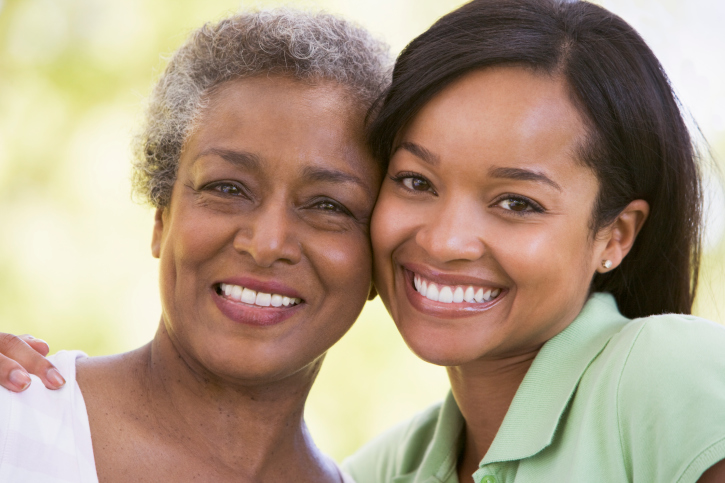 two women smiling outdoors