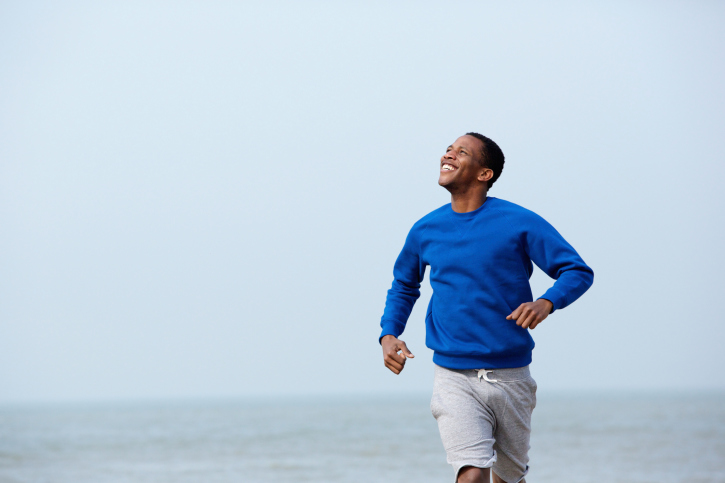 young man jogging on beach