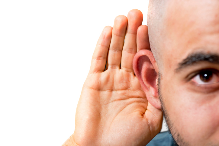 black man with hand to hear