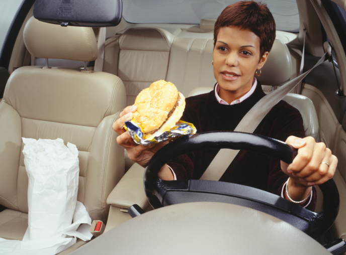 woman eating while driving