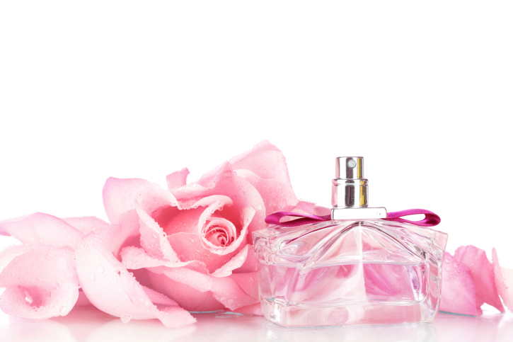 Perfume bottle and pink rose