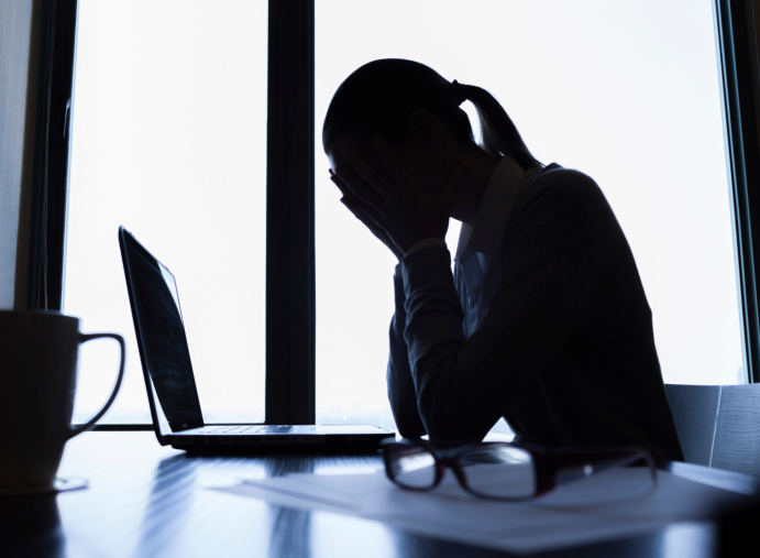 woman stressed at work dark