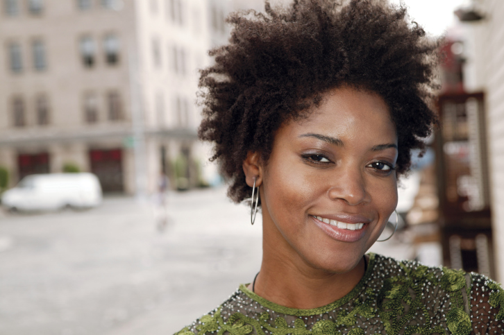 portrait of a smiling urban woman outdoors
