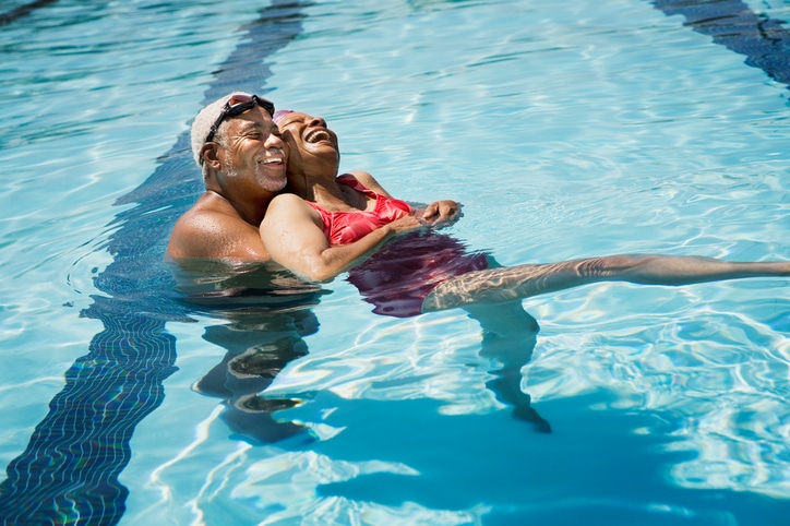 African American senior couple in swimming pool