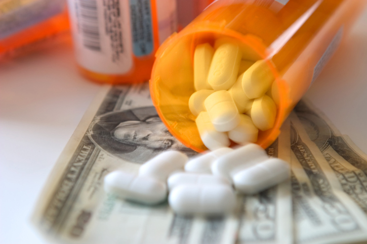 prescription bottles on top of cash