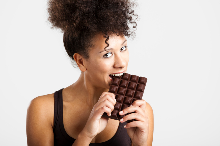 woman eating chocolate bar