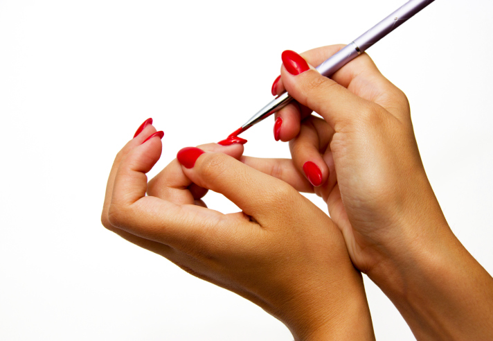 woman painting nails hands