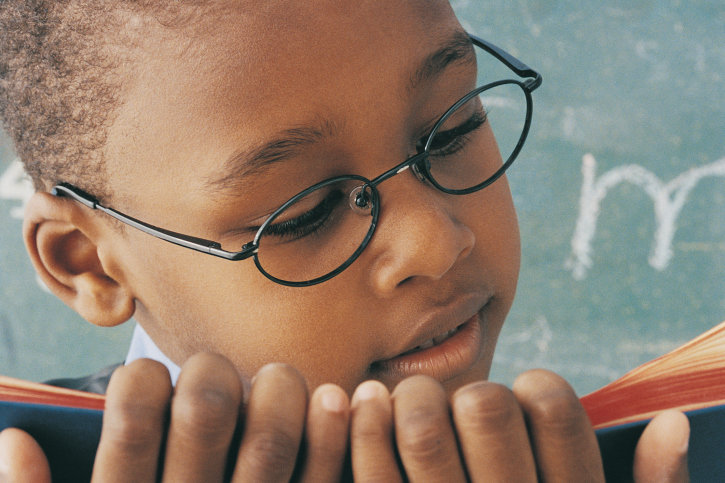 young boy reading book