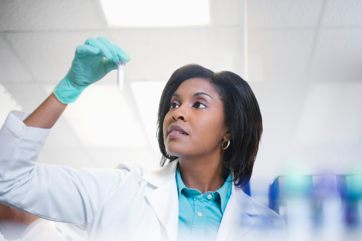 woman holding lab tube