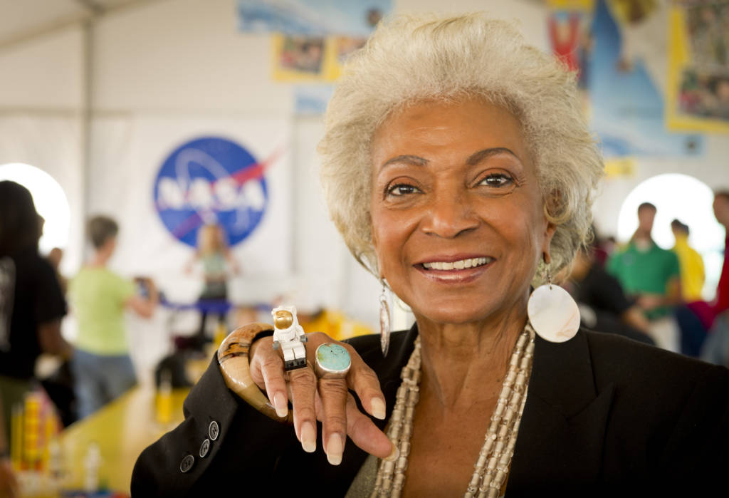 Actress Nichelle Nichols, known for her most famous role as communications officer Lieutenant Uhura aboard the USS Enterprise in the popular Star Trek television series, displays her Lego astronaut ring while visiting the âBuild the Futureâ activity where students created their vision of the future in space with LEGO bricks and elements inside a tent that was set up on the launch viewing area at NASA's Kennedy Space Center in Cape Canaveral, Fla. on Monday, Nov. 1, 2010.  NASA and The LEGO Group signed a Space Act Agreement to spark children's interest in science, technology, engineering and math (STEM). Photo Credit: (NASA/Bill Ingalls) NASA Identifier: nasahqphoto-5161637425