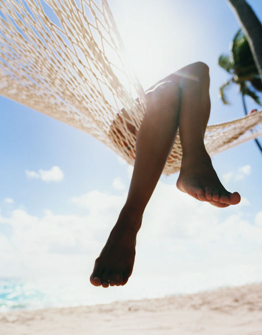 womans legs hammock on beach