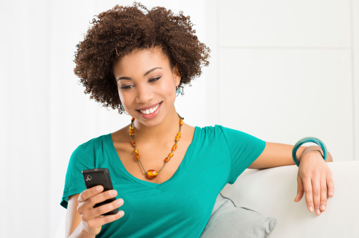 woman smiling at cell phone