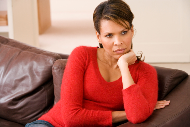 Depressed woman sitting on couch